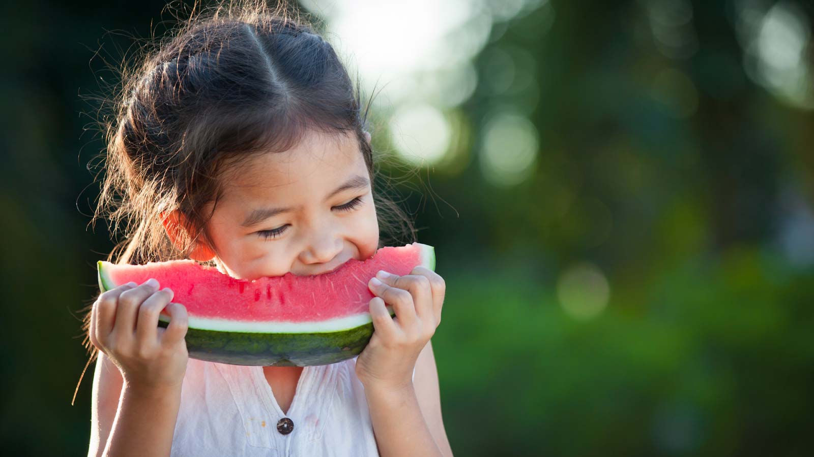 young girl eating watermelon