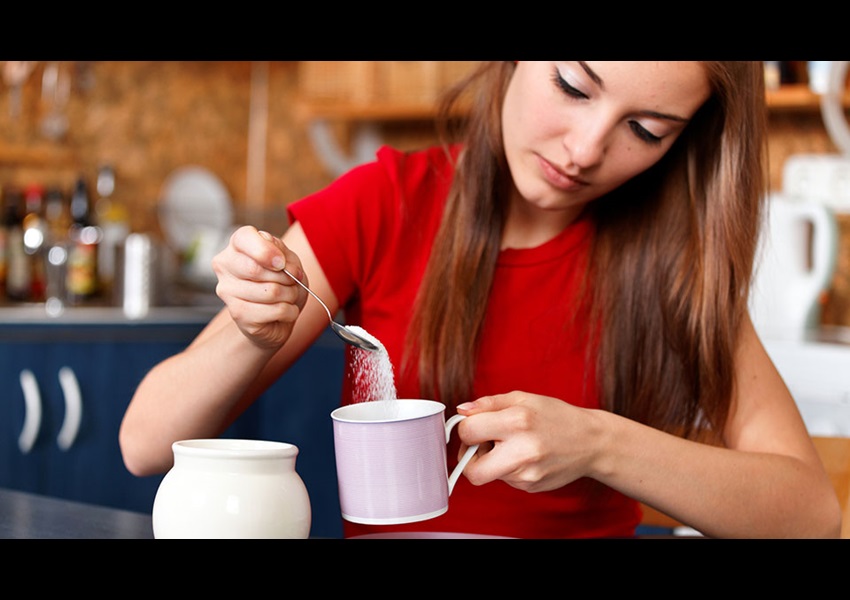 Woman Sweetening Coffee