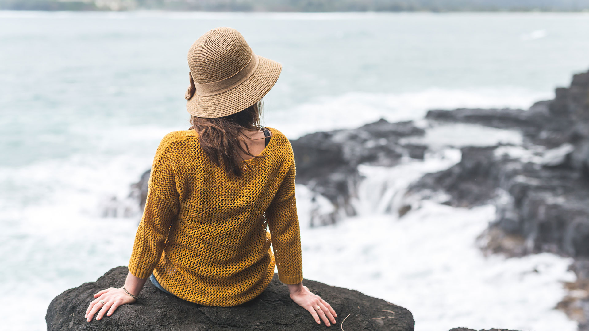 Women sitting by ocean.