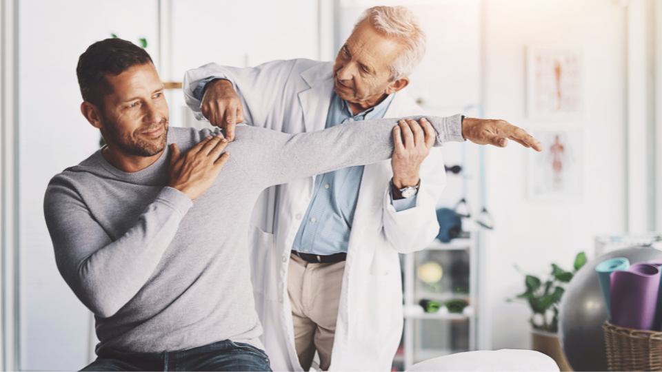 A doctor working on a patient's shoulder movement