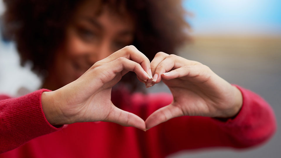 woman making a heart with her hands