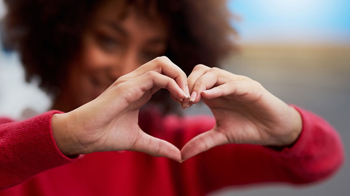 woman making a heart with her hands